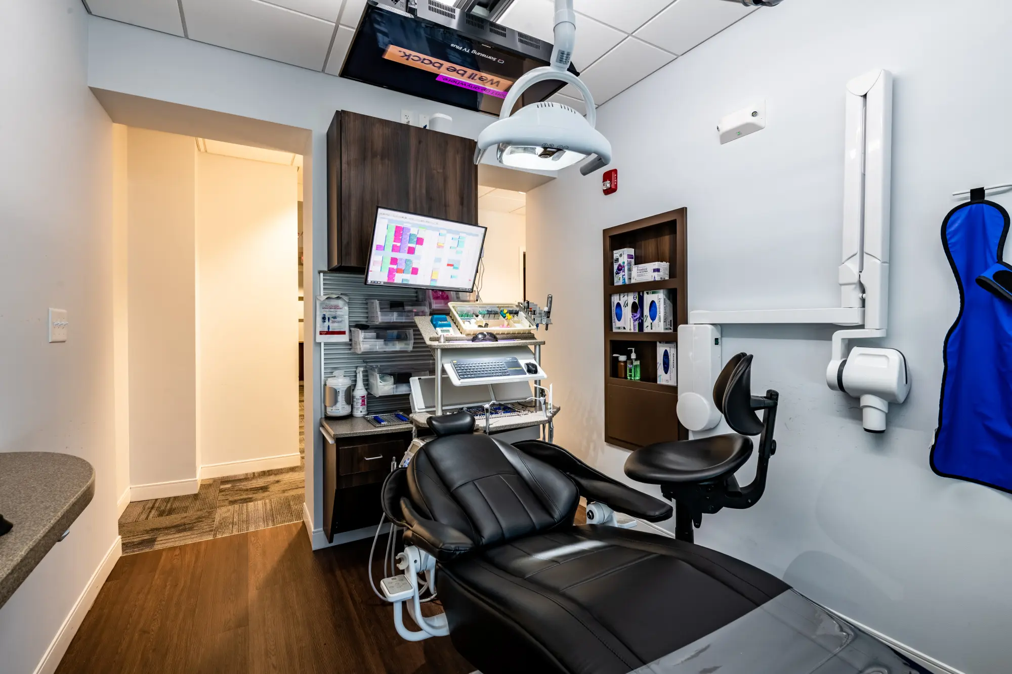 Dental Operatory with chair, X-ray, delivery, and monitors